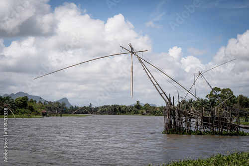 Large fishing nets on a river through the jungle in soutern Thailand photo