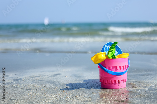 Children's toy in a basket on the beach in the sea.