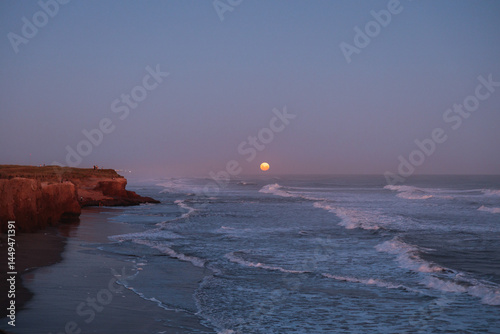 Full moon rising over the ocean in Mar del Plata photo