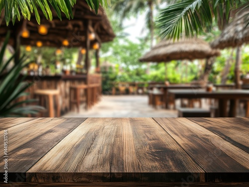 Rustic wooden table surface with blurred tropical outdoor restaurant background for product display
