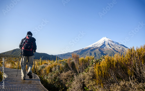 Obraz na płótnie Hiking Pouakai Circuit track. Snow-capped Mt Taranaki in the distance. Egmont National Park. New Zealand. w salonie