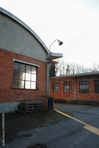 Sun blade shining amidst ancient industrial buildings