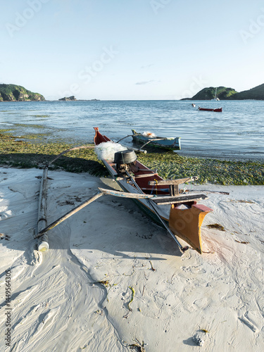 Fishing canoe beached on coastal sand