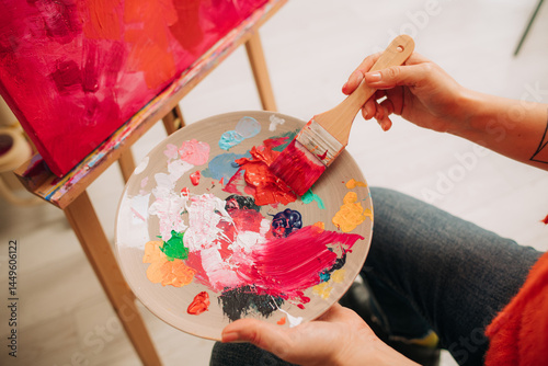 Vibrant paint palette with wide brush during canvas painting pro