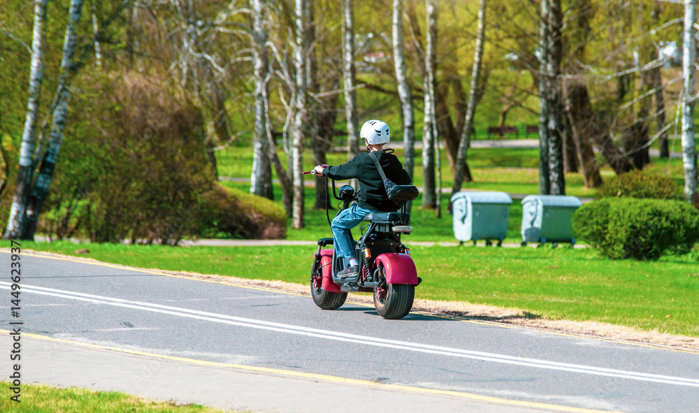 A man rolls on an electric scooter in the Park
A man rolls on an electric scooter in the Park