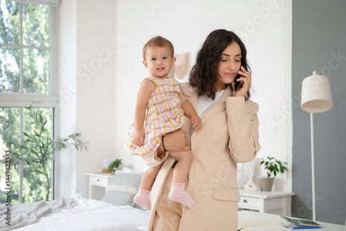 Working mother with her lit...