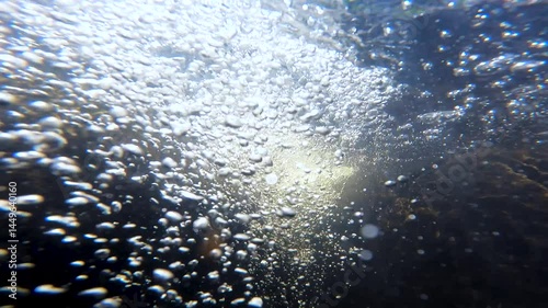 water bubble in a flowing stream through rock 