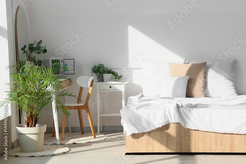 Interior of light bedroom w...