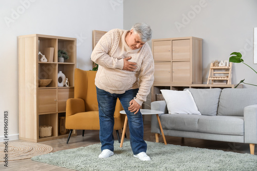 Senior man having heart att...