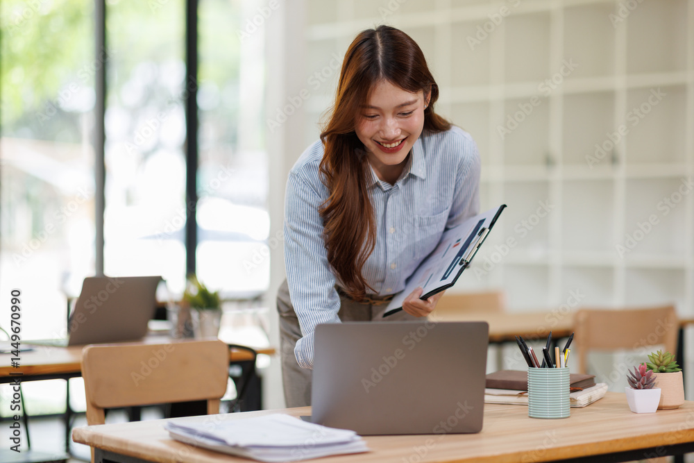 Young happy business asian woman working with clipboard tablet in corporate office
Young happy business asian woman working with clipboard tablet in corporate office