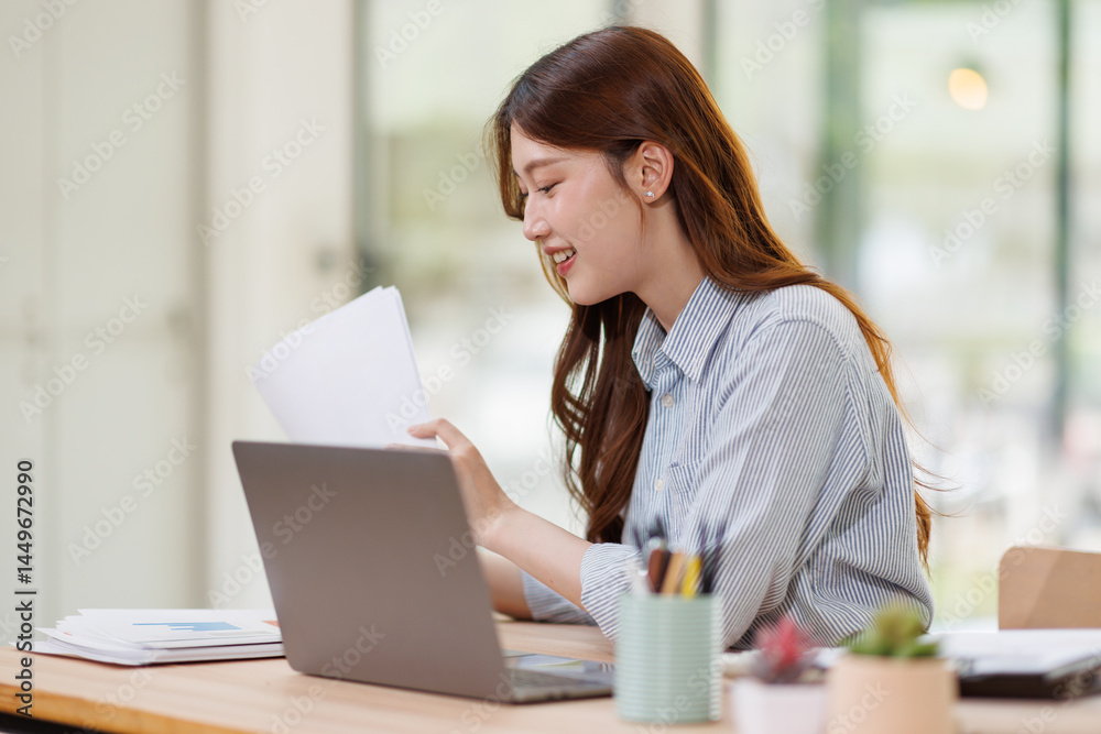 Smiling Young asian accountant business woman working with documents using calculator and laptop computer at office desk
Smiling Young asian accountant business woman working with documents using calculator and laptop computer at office desk