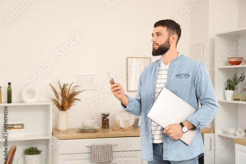 Young bearded man working w...
