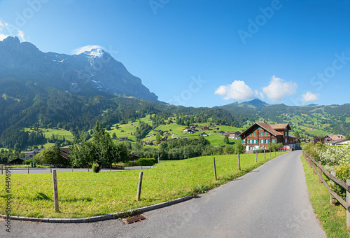 Obraz na płótnie chalet beside road in Grindelwald tourist resort, view to Eiger mountain and Kleine Scheidegg w salonie