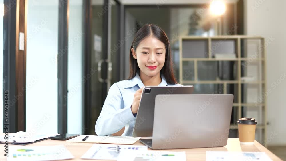 Asian businesswoman professional marketing manager using laptop working on computer to manage digital data and sitting in office Asian businesswoman professional marketing manager using laptop working on computer to manage digital data and sitting in office