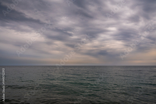 Fototapeta Naklejka Na Ścianę i Meble -  Ocean with sky in horizon. Calm sea in evening. Seascape at sunset.