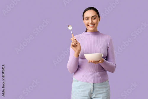Young woman with tasty soup...
