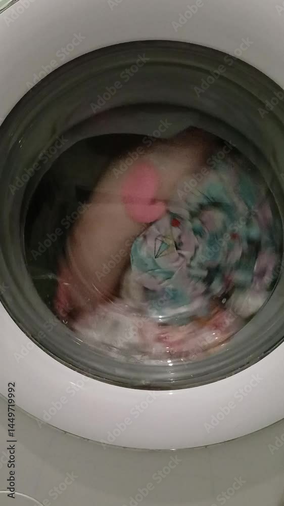 Washing machine is filling with water. Vertical video Washing machine is filling with water. Vertical video
