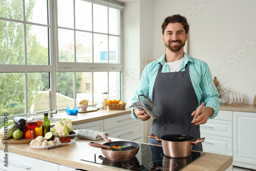 Smiling man in an apron coo...