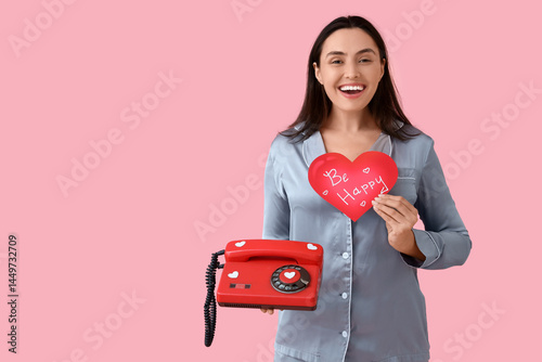 Happy woman in pajamas hold...