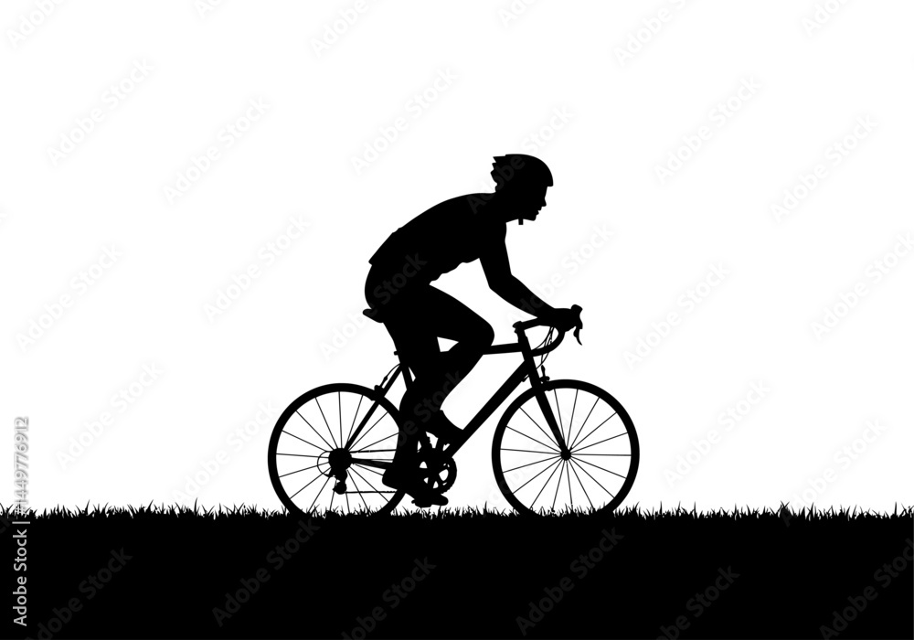 Fototapeta premium Silhouette of Cyclist Riding Road Bicycle on Grassy Landscape