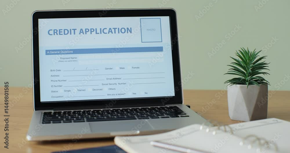 Online Credit Application form showing on a laptop computer screen sitting on a desk. Online Credit Application form showing on a laptop computer screen sitting on a desk.