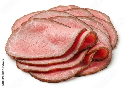 Stack of thinly sliced roast beef arranged on a white surface in a studio shot