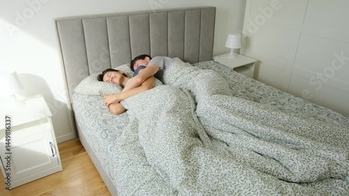 Couple celebrating birthday at home. Morning of the Birthday. Couple waking up on birthday morning, cozy atmosphere, gentle smiles, natural light fills the room. Casual start to special day at home. photo