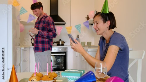 Couple talking to friends via video call, laptop screen, joyful communication, virtual celebration, connection across distance. Happy birthday at home photo