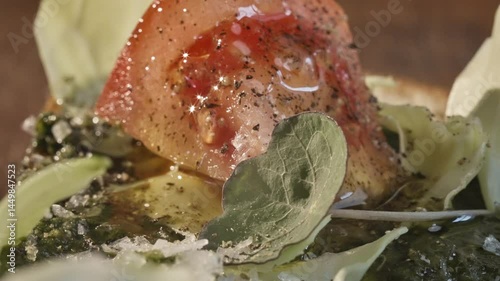 Food preparation. Close-up of a chef pouring olive oil on a salad with cucumbers, tomatoes and cheese. Healthy eating concept. Slow motion 50fps.