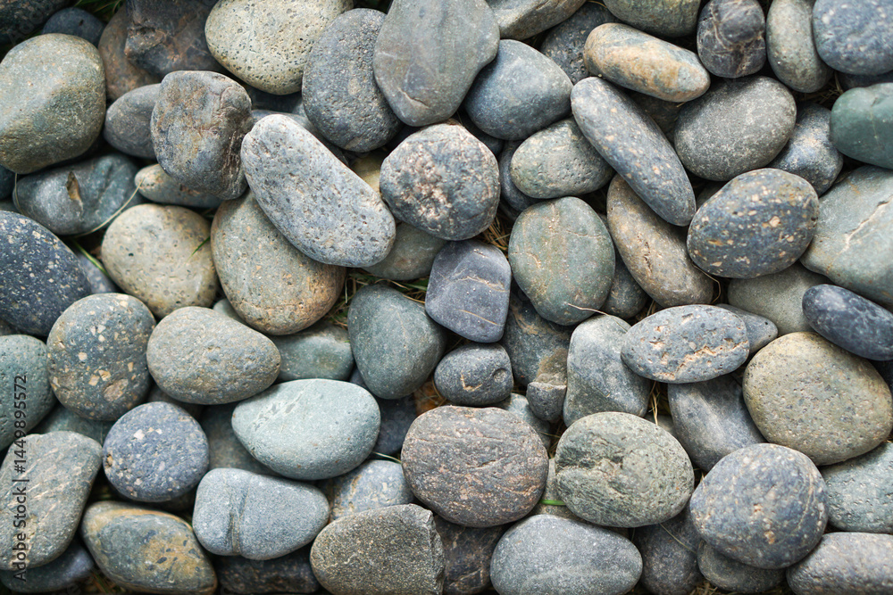Background pattern of river pebbles of alternating sizes and shapes. Background pattern of river pebbles of alternating sizes and shapes.