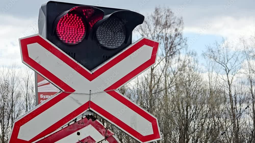 A red and white traffic light with a red light on top and a red light on the bottom