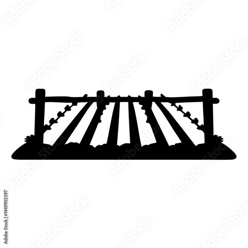 Silhouette of a rural field divided by a rustic wooden fence