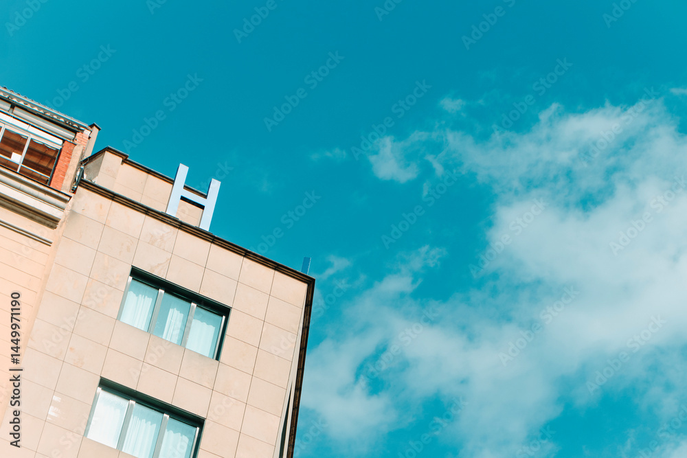 building topped with a blue H letter