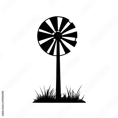 Windmill stands tall amidst green grass in a rural setting showing the beauty of nature and traditional farming practices