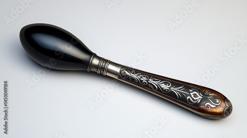Studio close-up of a silver-plated shoehorn with an engraved handle, ultra-sharp clarity on an ideal white background.