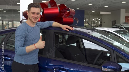 Happy male customer gives a thumbs up next to a stylish car