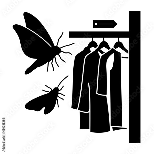 Moth silhouette flying near clothes in closet, summer insect control