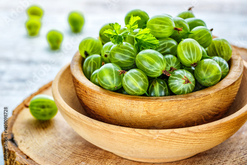 Green Organic Berries Gooseberries.Green gooseberries in a wooden bowl.Gooseberries on the wooden table. Harvest concept. Vegetarian food.