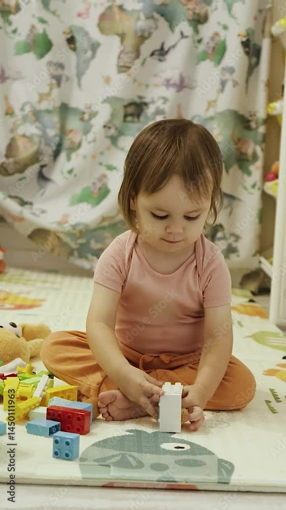 Vertical screen: A happy toddler is joyfully playing with colorful toys in a cozy, inviting room setting Vertical screen: A happy toddler is joyfully playing with colorful toys in a cozy, inviting room setting