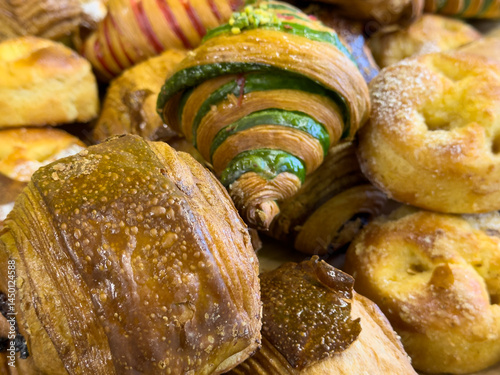 A variety of freshly baked pastries, including croissants, bread rolls, and more.