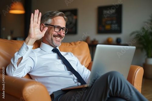 Remote work routine.. Man sits at home, embracing flexible work arrangement with laptop and waving goodbye to office life.