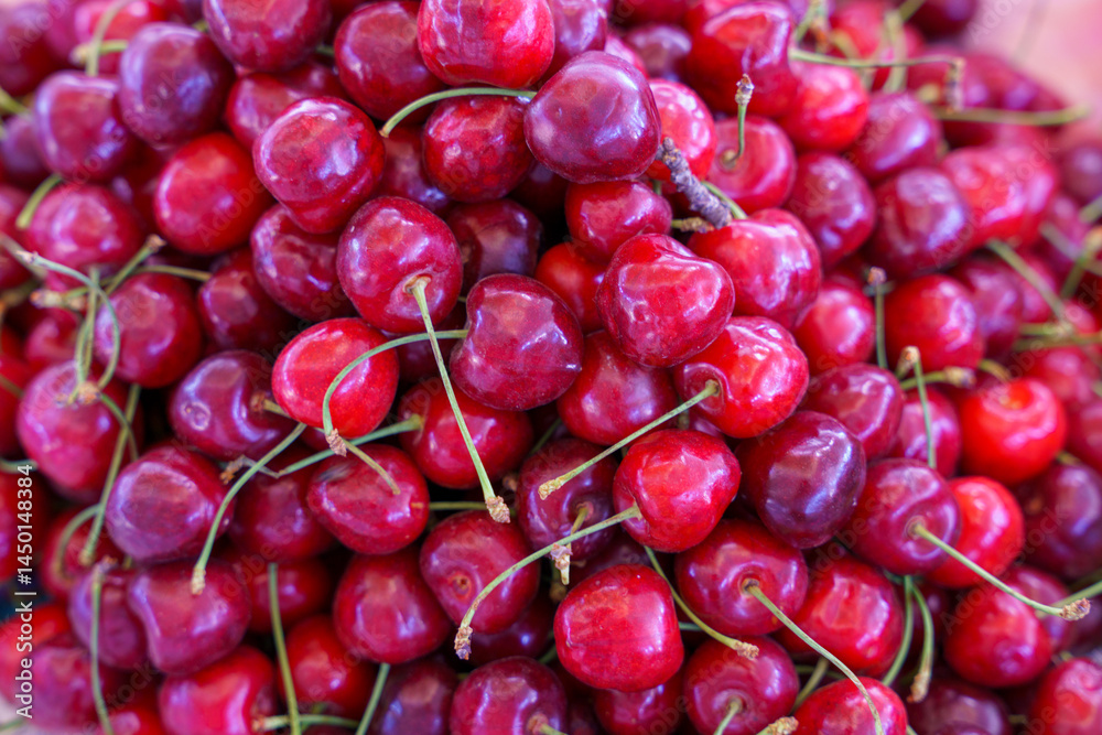 A bunch of red cherries with green stems A bunch of red cherries with green stems