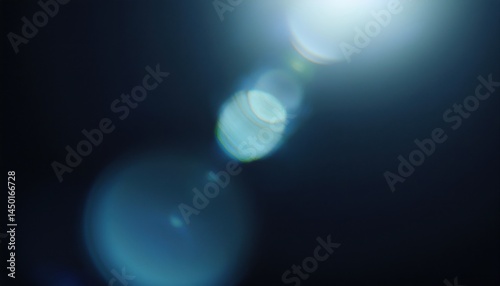 abstract blue lens flare bokeh light effect on dark background for digital artwork, web design, print layouts, branding visuals, or motion graphics

