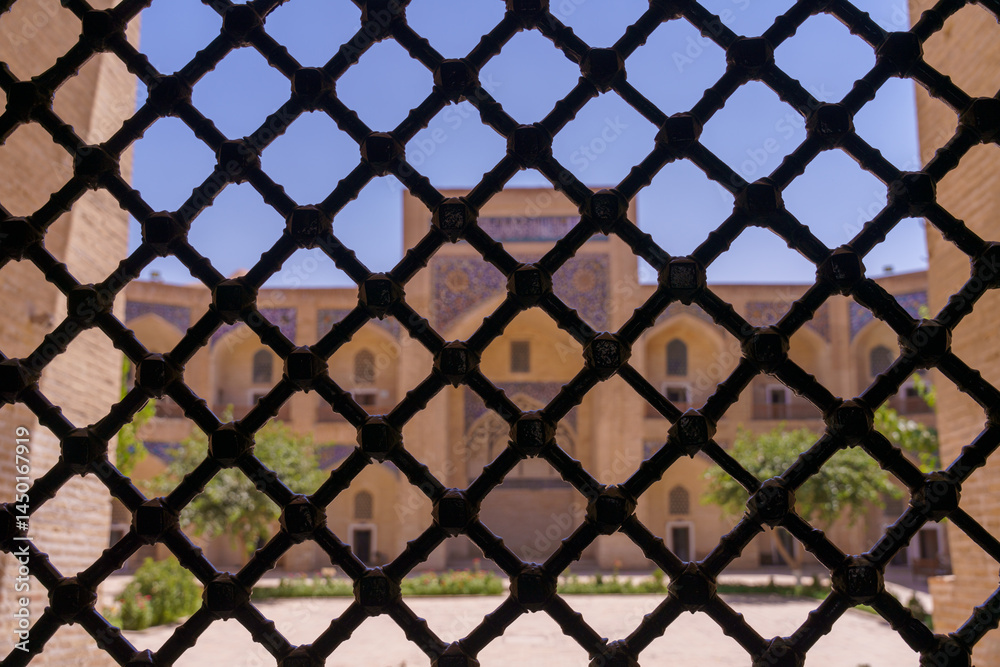 Fototapeta premium A view of a building with a black metal fence