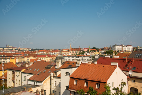 Panoramic view over Prague with orange rooftops and blue sky