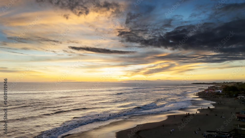 sunset on the western horizon at the edge of canggu beach, bali, indonesia sunset on the western horizon at the edge of canggu beach, bali, indonesia