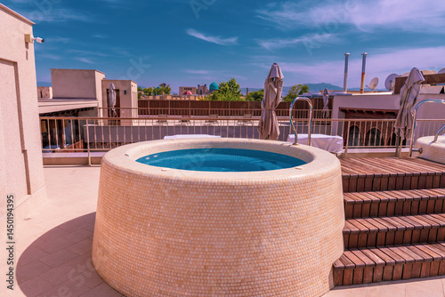 A small pool with a blue top is on a roof