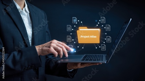 Person interacting with a digital project folder on a laptop. photo