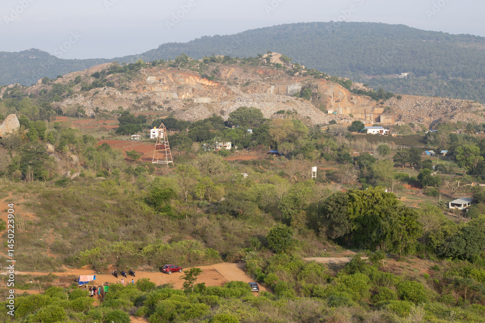 Obraz premium Aerial view of village of yelagiri from the mountain top, a top view, mountains covered with mist. Yelagiri hill station, nearest to Chennai