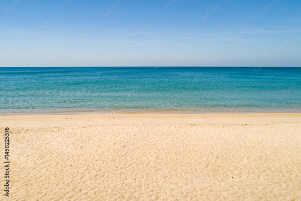 Obraz premium Aerial view of a blue sea surface water texture background and sun reflections Aerial flying drone view Waves water surface texture on sunny tropical ocean in Phuket island Thailand